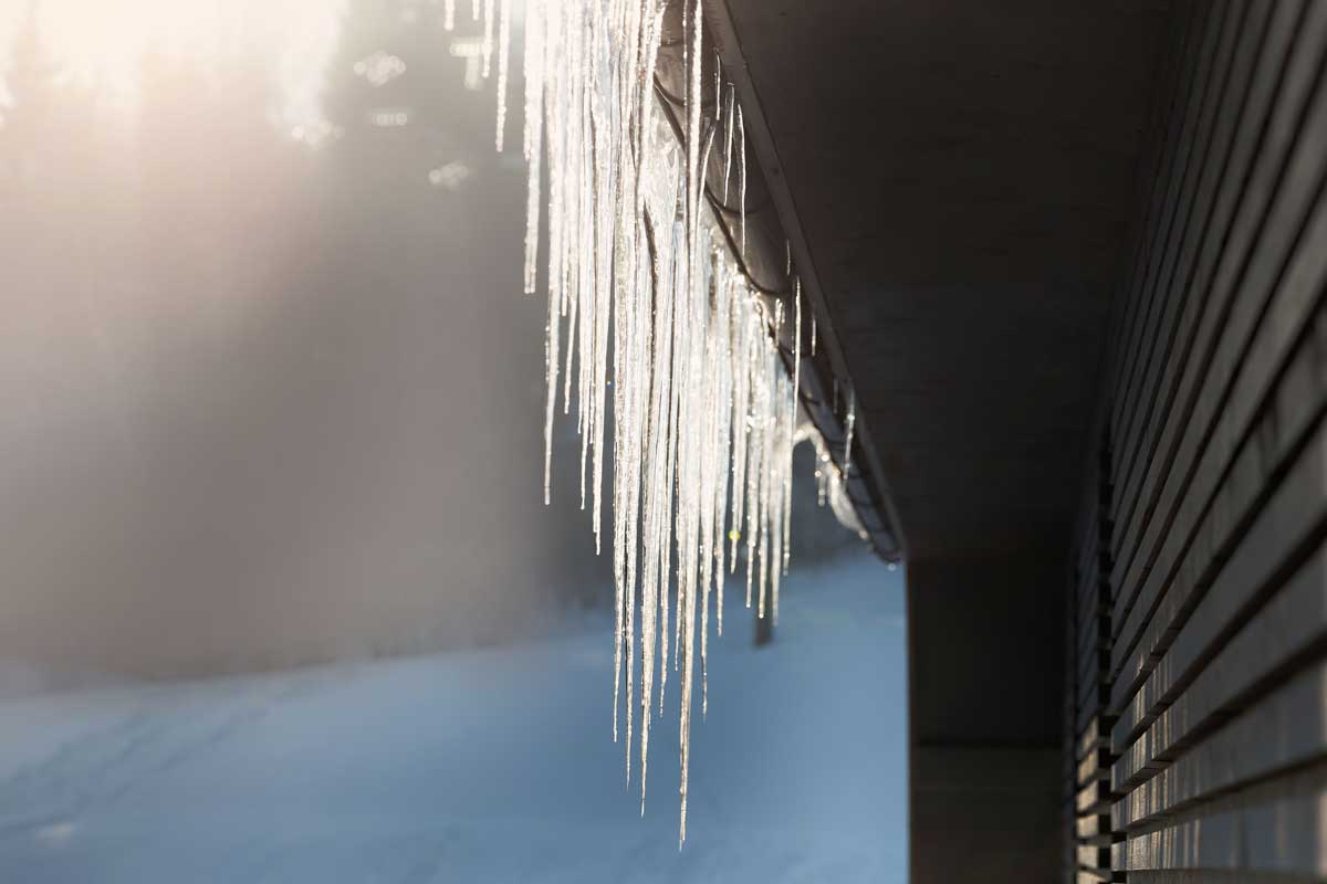 Icycles hanging off the side of a flat roof