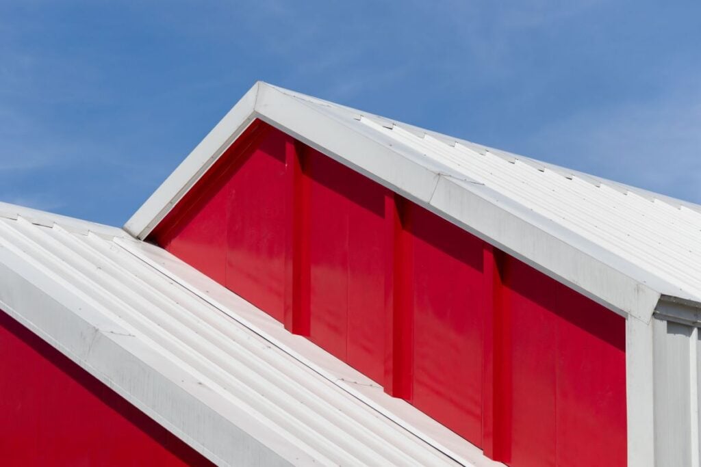 Sharp Angle View Of A Red Commercial Building With A Metal Roof