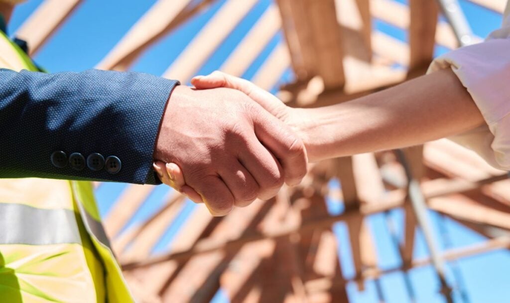Contractor And Building Engineer Shaking Hands, Close Up