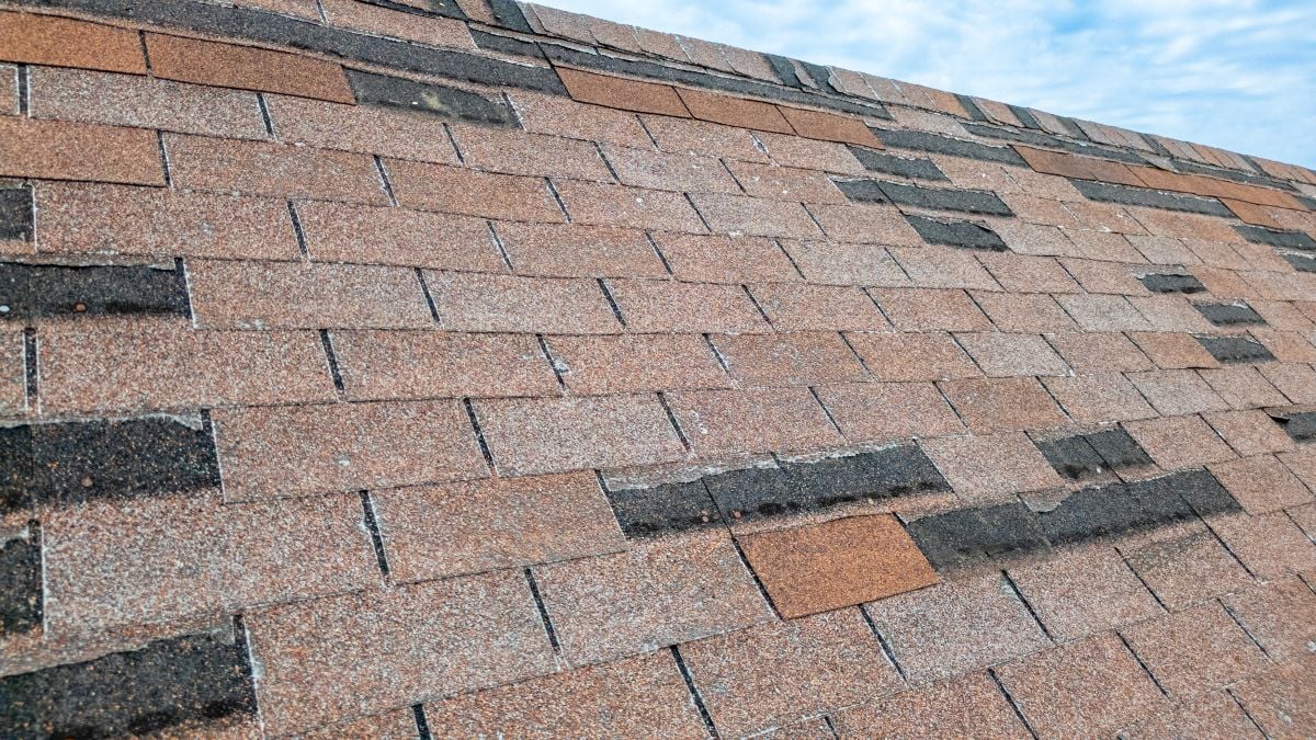 Roof With Missing Shingles From Storm Damage And Old Age