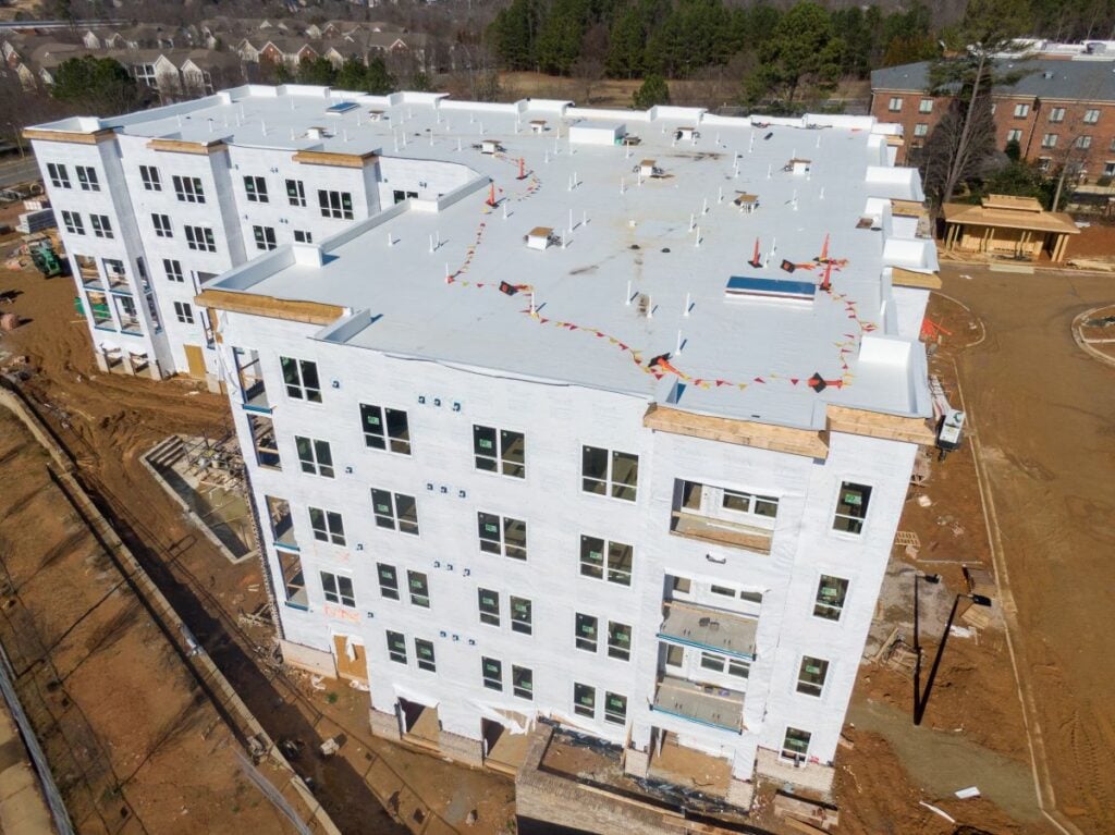 Aerial View Of Tpo Roof On Modern Apartment Building Under Construction