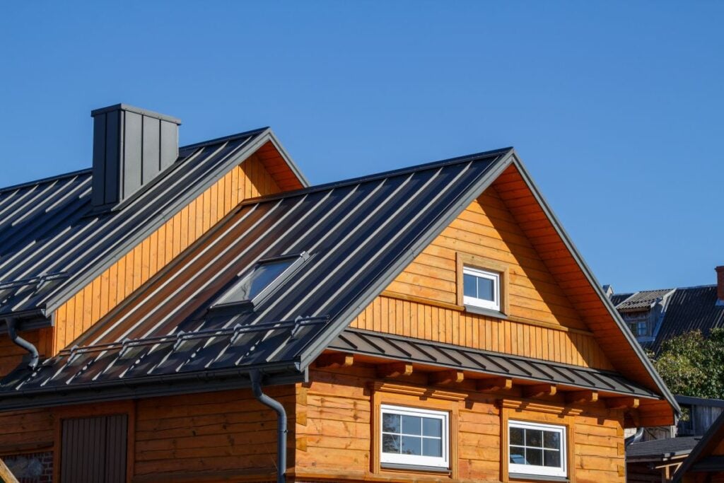 Wooden Houses. Classic Metal Roof. Metal Roofing Repair