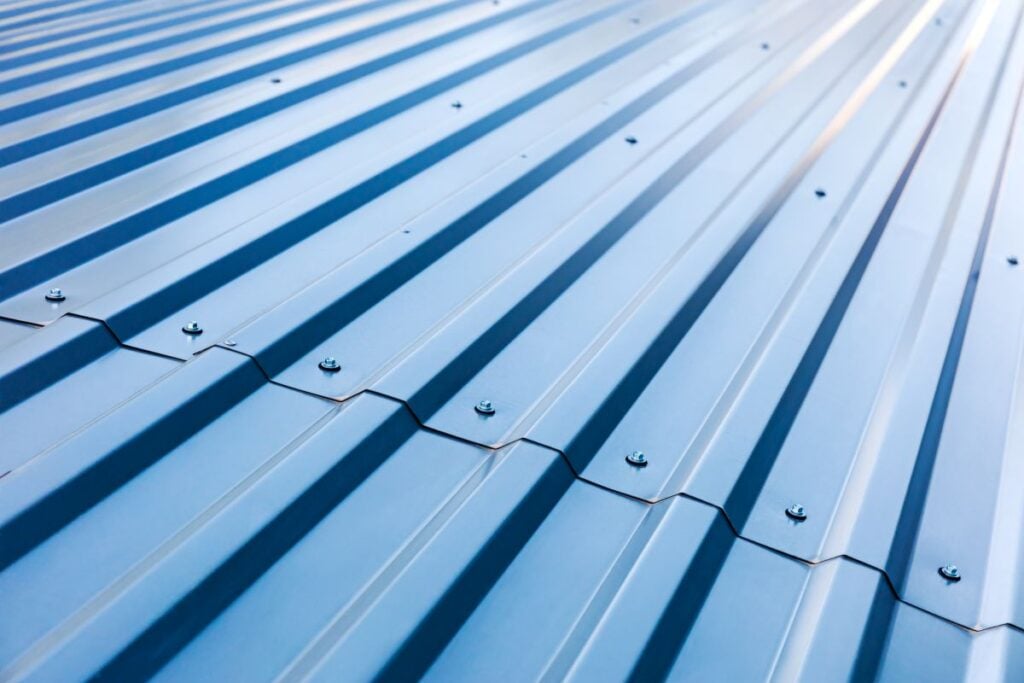Blue Corrugated Metal Roof With Rivets. How Long Do Metal Roofs Last?